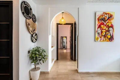 a hallway with a clock and a potted plant at Relaxing stay with pool & secure parking in Marrakech