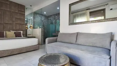 a living room with a couch and a mirror at Aman Bungalow - heated pool, not overlooked in Marrakech