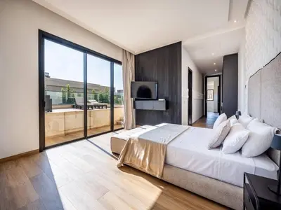 a bedroom with a large bed and a large window at Le Palais Zahira & Palais Mahora 2 villas in Marrakech