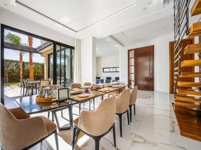 a dining room with a long table and chairs at Le Palais Zahira & Palais Mahora 2 villas in Marrakech
