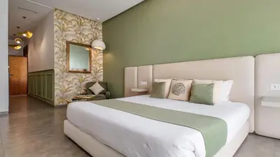 a bedroom with a large white bed in a room at Beautiful AWAL Villa, 6 suites & heated pool in Marrakech