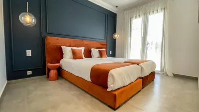 a bedroom with a large bed with blue walls at Villa JAMAL with heated pool in Marrakech in Marrakech
