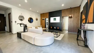a living room with a white couch and a table at Beautiful Asma Villa with heated pool in Marrakech