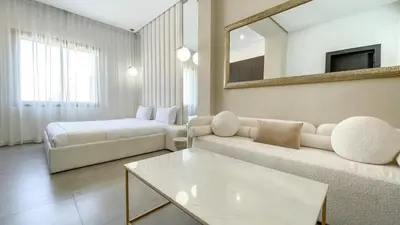 a living room with a couch and a bed and a mirror at Beautiful Asma Villa with heated pool in Marrakech