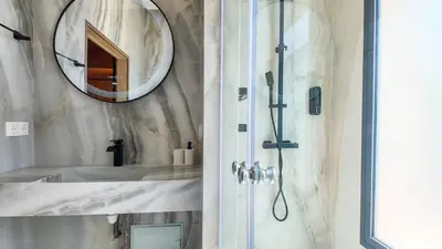 a bathroom with a shower and a mirror at Villa Nour heated pool not overlooked in Marrakech