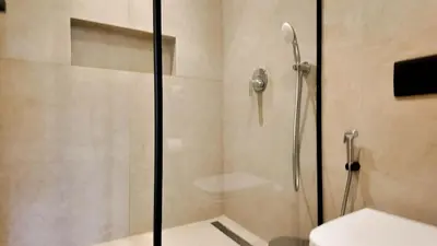 a bathroom with a shower with a glass door at Majorelle Bungalow - Heated pool, not overlooked in Marrakech