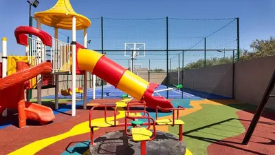 a childrens playground with a slide and a slideintend at Targa Bungalow - Heated pool, not overlooked in Marrakech