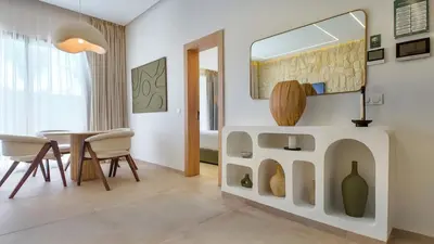 a living room with a table and a mirror at Targa Bungalow - Heated pool, not overlooked in Marrakech