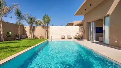 a swimming pool in the backyard of a house at Palm Grove Bungalow - Heated pool, not overlooked in Marrakech