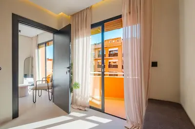a room with a door with a view of a building at Havre de paix moderne pour voyageurs exigeants in Marrakech