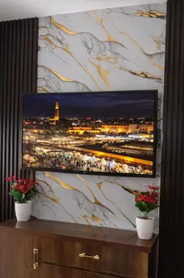 a flat screen tv sitting on a wall at Appartement 2 Chambres Marrakech Targa Parking WiFi in Marrakech