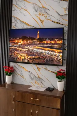 a flat screen tv sitting on top of a dresser at Appartement 2 Chambres Marrakech Targa Parking WiFi in Marrakech