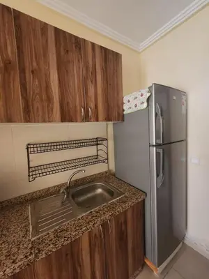 a kitchen with a sink and a refrigerator at Aéroport appartement Marrakech in Marrakech
