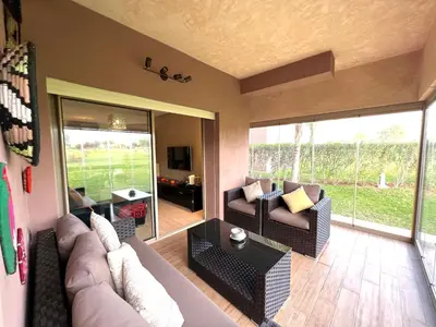 a living room with a couch and a table at Golf Prestigia Marrakech in Marrakech