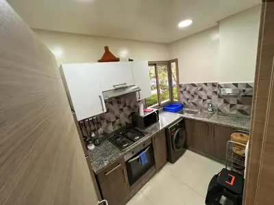 a kitchen with a sink and a stove top oven at Golf Prestigia Marrakech in Marrakech