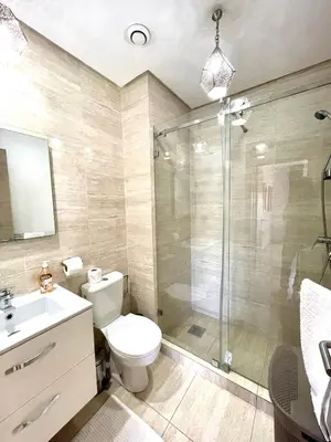a bathroom with a shower and a toilet and a sink at Golf Prestigia Marrakech in Marrakech