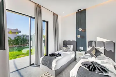 a bedroom with two beds and a large window at Villa Prestige Privée avec Vue Splendide in Marrakech
