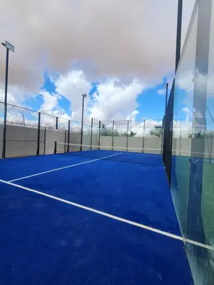 a tennis court with a fence and a tennis court at Villa Prestige Privée avec Vue Splendide in Marrakech