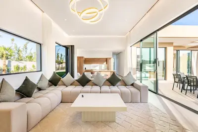 a living room with a couch and a table at Beautiful Villa 15 min Center, Jacuzzi, Padel in Marrakech