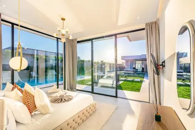 a living room with a couch and a large window at Beautiful Villa 15 min Center, Jacuzzi, Padel in Marrakech