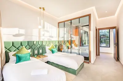 a bedroom with two beds and a mirror at Beautiful Villa 15 min Center, Jacuzzi, Padel in Marrakech