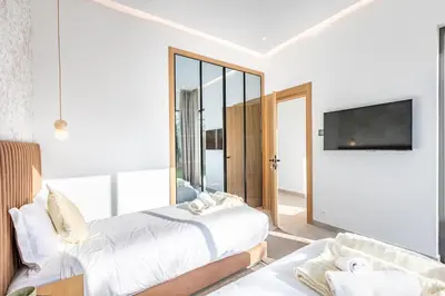 a bedroom with a bed and a tv on a wall at Heated Pool Absolute Luxury in Marrakech
