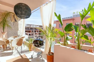 a balcony with plants and a table and chairs at Apartment in Victor Hugo 10 minutes from Jemaa el-Fna in Marrakech