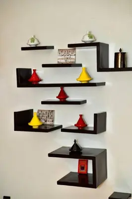 a wall with black shelves with red and yellow lights at Marrakech Centre Guéliz – Calme & authentique in Marrakech