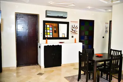 a dining room with a table and a mirror at Marrakech Centre Guéliz – Calme & authentique in Marrakech