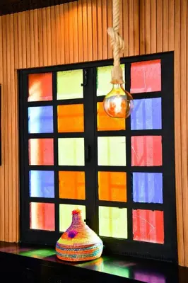 two vases on a table in front of a colorful window at Marrakech Centre Guéliz – Calme & authentique in Marrakech