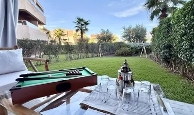 a ping pong table with a pool game on it at Prestigia JADE Luxury and comfort Private Garden in Marrakech
