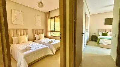 a bedroom with two beds and a window at Prestigia JADE Luxury and comfort Private Garden in Marrakech