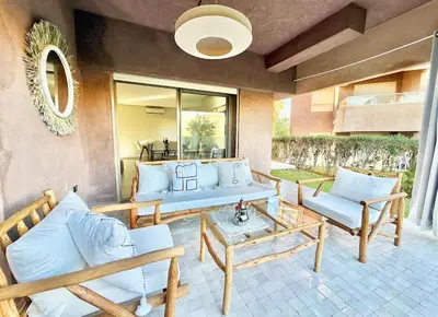 a patio with couches and a table and chairs at Prestigia JADE Luxury and comfort Private Garden in Marrakech