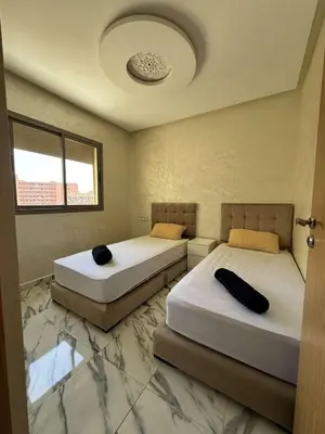 two beds in a room with two beds sidx sidx sidx sidx at Appartement à gueliz in Marrakech