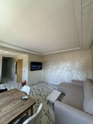a living room with a couch and a table at Appartement à gueliz in Marrakech
