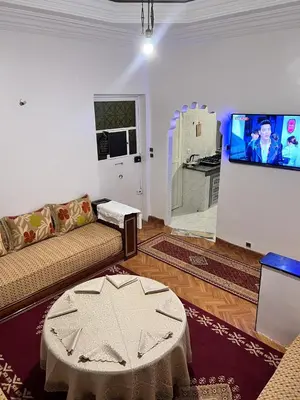 a living room with a couch and a flat screen tv at Spacious Family Apartment near Jemaa el-Fnaa in Marrakech