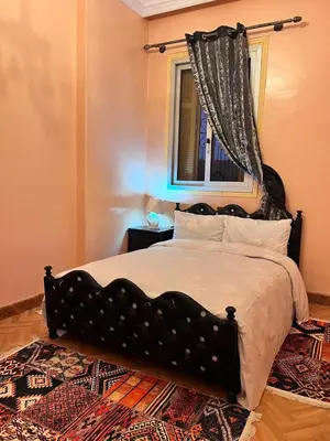 a bedroom with a large bed with a window at Spacious Family Apartment near Jemaa el-Fnaa in Marrakech