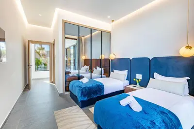 a hotel room with two beds with blue sheets at Diamond Serenity House in Marrakech