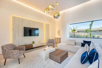 a living room with a couch and a tv at Villa Magique Piscine Chauffée Et Jacuzzi in Marrakech