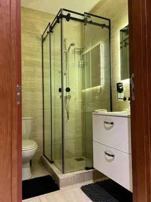 a bathroom with a glass shower with a toilet at Appart Essalam 2 in Marrakech