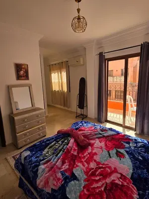 a bedroom with a bed and a dresser and a window at apartt le Palmier de Guéliz in Marrakech