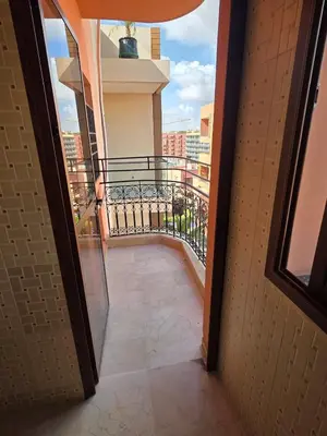 a view of a balcony from an open door at apartt le Palmier de Guéliz in Marrakech