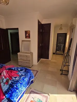 a room with a bed and a dresser in it at apartt le Palmier de Guéliz in Marrakech