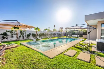 a swimming pool in the yard of a house at Villa with jacuzzi in Marrakech