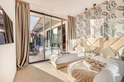 a bedroom with two beds and a balcony at Villa with jacuzzi in Marrakech