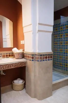 a bathroom with a tub and a sink and a mirror at Central location in Gueliz in Marrakech