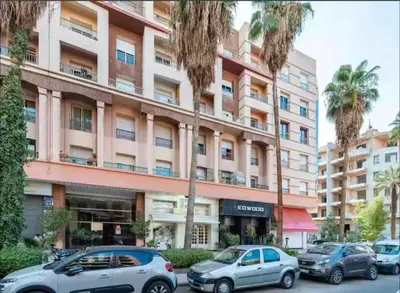 two cars parked in front of a large building at Central location in Gueliz in Marrakech