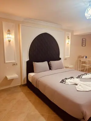 a bedroom with a large bed with a large headboard at Blue and sun Majorelle comfort and spacious in Marrakech