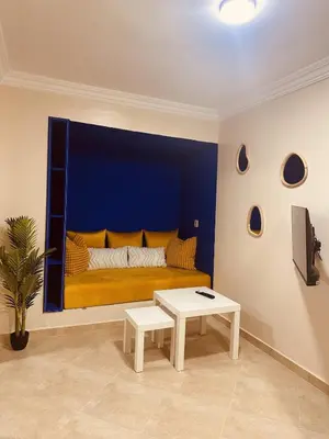 a room with a bed with a blue wall at Blue and sun Majorelle comfort and spacious in Marrakech