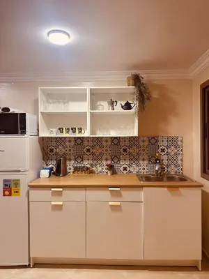 a kitchen with white cabinets and a sink at Blue and sun Majorelle comfort and spacious in Marrakech